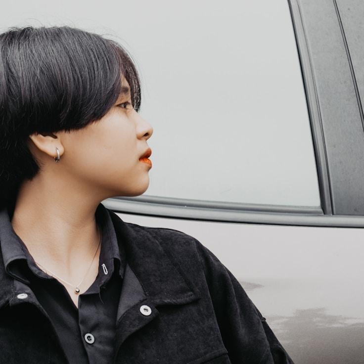 Avery Collins, Lead Design Curator at Haven Faint Pathway, reviewing corporate floral arrangements